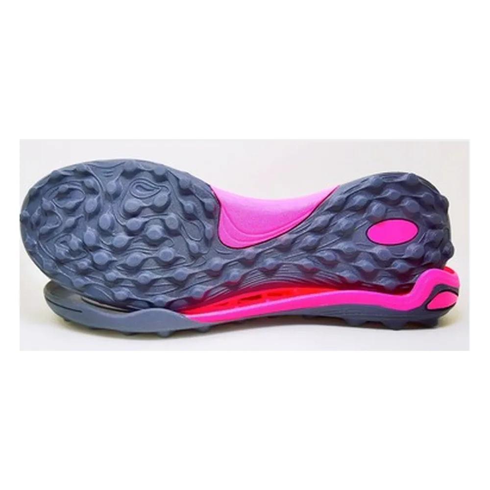 Slate gray and magenta turf soccer outsole with wavy low-profile lugs and oval heel window