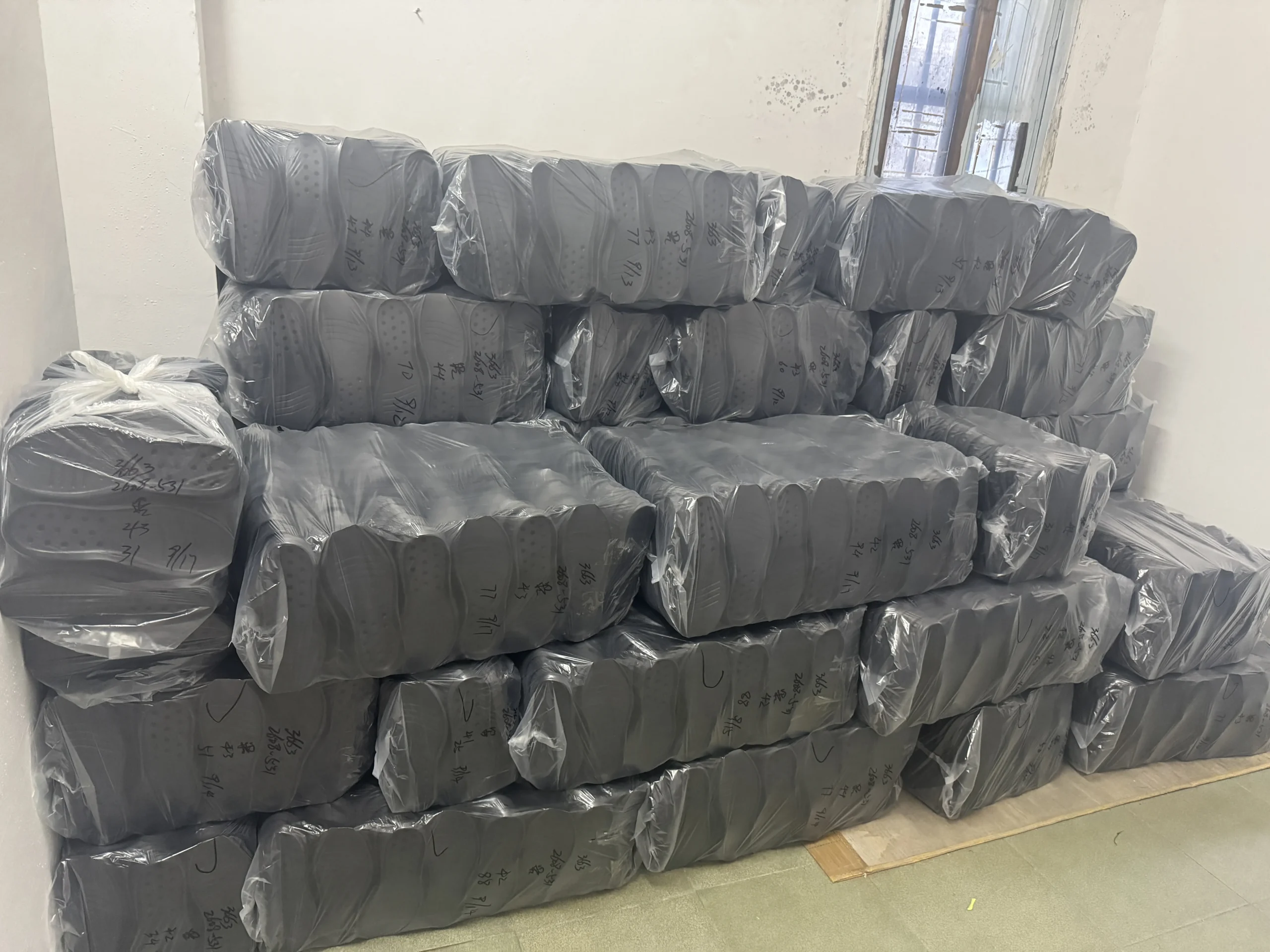 Sports shoe soles bundled and protected for packing