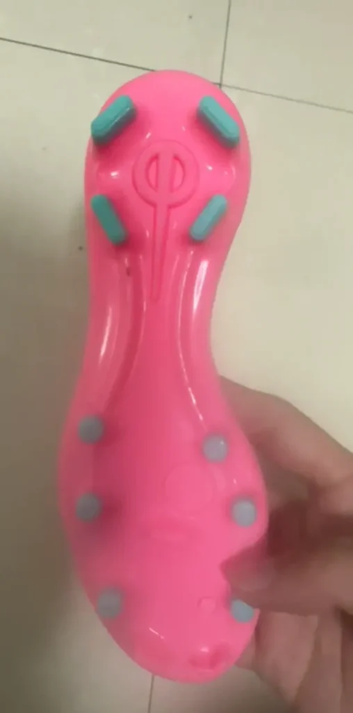 Pink football shoe outsole showing a molded relief logo