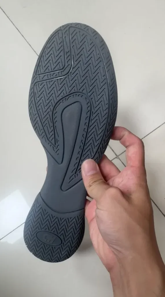 Gray rubber boxing shoe outsole showing herringbone tread on the forefoot and heel