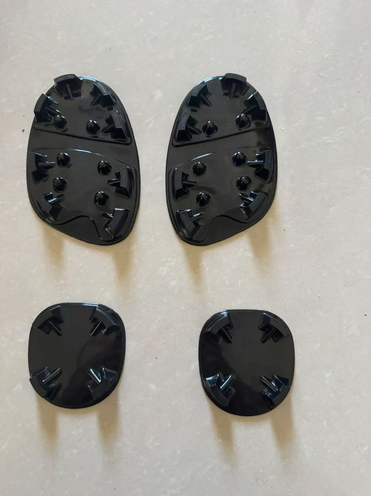 Black TPU baseball cleat sole components with separate forefoot and heel pieces for sneaker conversion